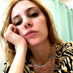 Introspective pose with zebra print top