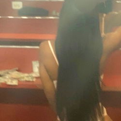 Layli - OnlyFans Model in Red Dress and Long Ponytail Sitting in Red Chair