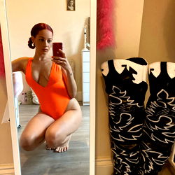 Cherub's Playful Pose in Orange Swimsuit and Cowboy Boots