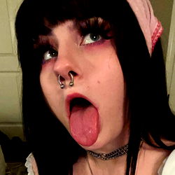 Tattooed Gothic Style Model with Tongue Out