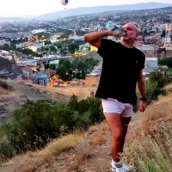 A Man Enjoying a Beer on the Hills