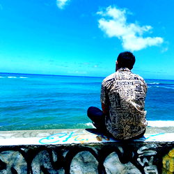 Urban Hawaiian Scene with Man in Flowered Shirt and Graffiti Wall