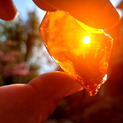 An Image of a Person Holding a Yellow Amber Piece
