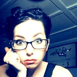 Aurora Hart, a young woman with striking eyes, showcasing her playful and intellectual personality.