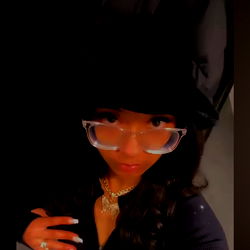 Stylish Model Posing in Vibrant Outfit with Glasses and Necklace