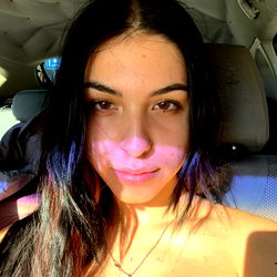 Cool and casual portrait of Pinkyperra with a playful smile