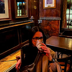 An individual savoring a beverage in a bar setting