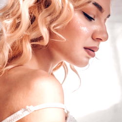 A young woman posing with her eyes closed