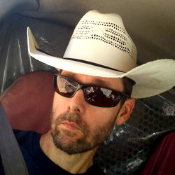 A Cowboy-Hatted Driver in a Car