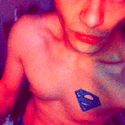 Fit and Tattooed Man in Superhero Undershirt