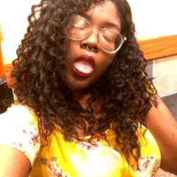 A Woman with Short Curly Hair and a Yellow Blouse in an Exuberant Mood