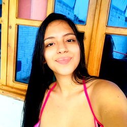 A beautiful model posing for a photo in an outdoor setting.