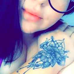 Stylish Tattooed Woman with Cat-Eye Glasses