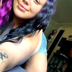 Miss-E, a vibrant Instagram model with a unique purple hair style