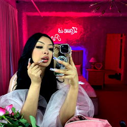 Nearby Model Madelyn, Stylized Photo on Platform with Pink Aesthetic and Personal Items