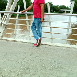 A person walking on a bridge at dusk