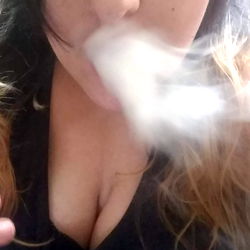 A woman with a smoke ring in her mouth