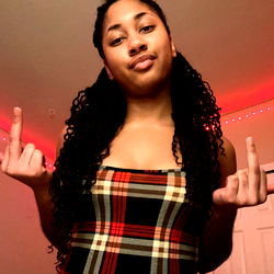 Onlyfans Model Showcasing a Plaid Outfit and Finger Gesture