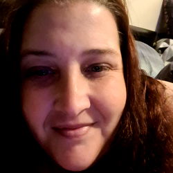 Woman with a slight smile, taken from the side