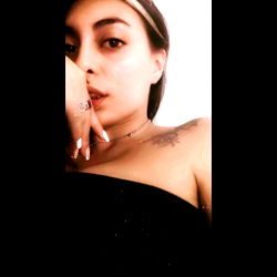 Young Adult Woman in Strapless Black Dress with Ring and Tattoo