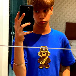 Cute Guy with Blue Shirt and Monkey Face Design Taking Selfie