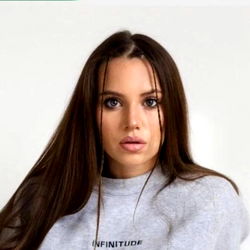 Aleksandra, the stunning model with a radiant smile and long brown hair,