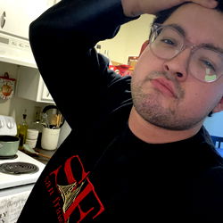 Person in a Kitchen with Glasses and a Beard