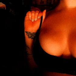 OnlyFans Model in Low Light, Showing Part of Body and a Small Portion of Face