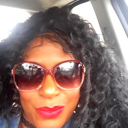 A Woman Smiling at the Camera from Her Car