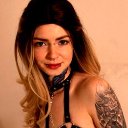 OnlyFans Model in Tattooed and Strap-Based Attire