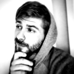 Bearded Man in Hoodie Thinking and Drinking