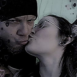 A couple sharing a tender moment amidst an indoor setting