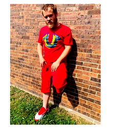 Strong, Athletic Man in a Casual Outfit Standing Against a Brick Wall