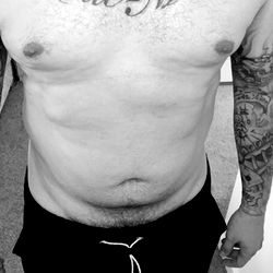 Fit and Tattooed Man in Casual Attire