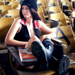 Stylish Model Sitting in Empty Auditorium