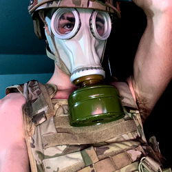 Military Man in Mask with Gas Canister on Chest