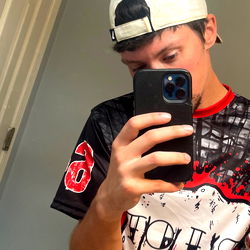 A Young Man Taking a Selfie in the Mirror with OnlyFans Swag