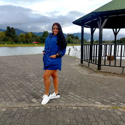 Aleja W, a Model Standing on a Brick Walkway