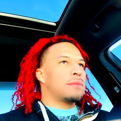 Rapper in Car with Red Hair and Dreadlocks