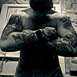 Bearded Man in Tattoos Crossed Arms