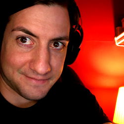 Young Man with Headphones, Looking Intently at Camera