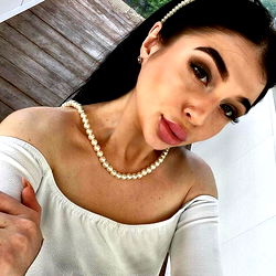 Stylish Alina Sweet in White Blouse and Pearl Necklace, Poland