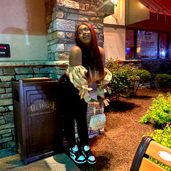Taki Poses with Potted Plant on Balcony