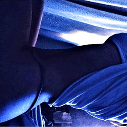 Female Onlyfans Model in Racy Pose with Blue Light