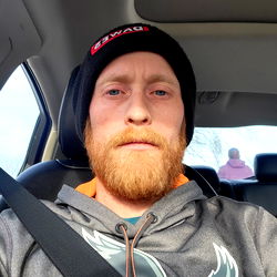 The Man in the Car with Beard and Hat