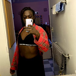 A young woman taking a selfie in her bathroom