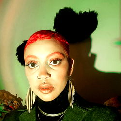 Stylish Individual with Colorful Hair and Eye Makeup