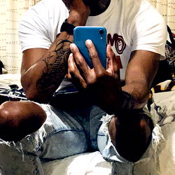 Young Male in a Casual Setting Taking a Selfie with Phone