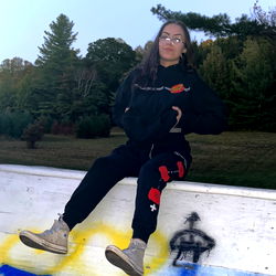 Model Posing with Graffiti Backdrop