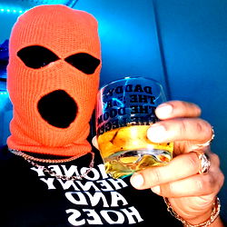 Individual in mask celebrating with drink